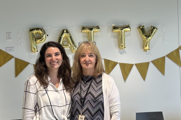 Mary Catherine Pflug and Pat Lightizer at party celebrating Patty's years of service at Monotype, balloons spelling "Patty" on the wall.